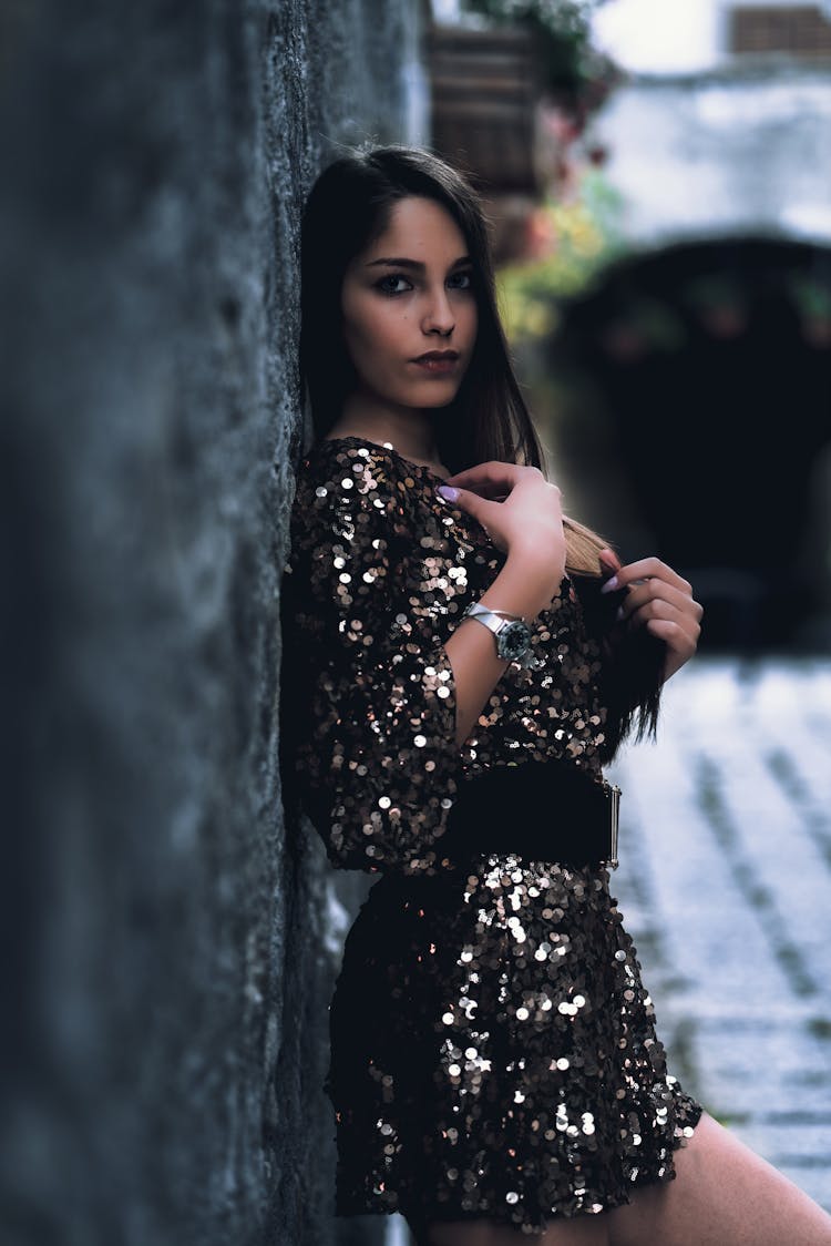 Photo Of Woman In Black Sequin Dress Leaning On Wall