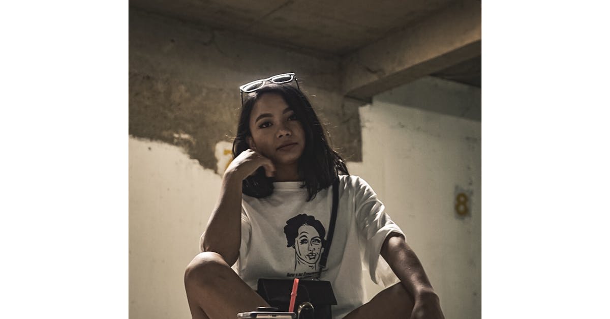 Woman in White Shirt Sitting on Floor · Free Stock Photo