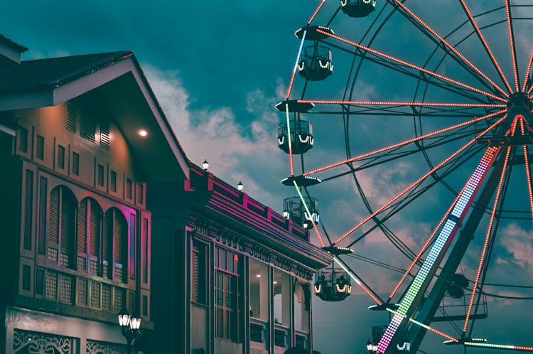 Illuminated Ferris Wheel In Amusement Park