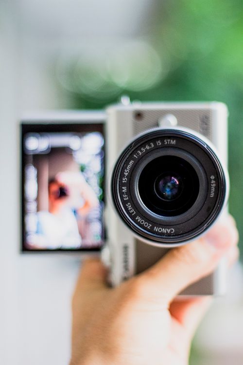 Free Detailed view of a camera with flip screen showing a blurred selfie. Perfect for tech enthusiasts. Stock Photo