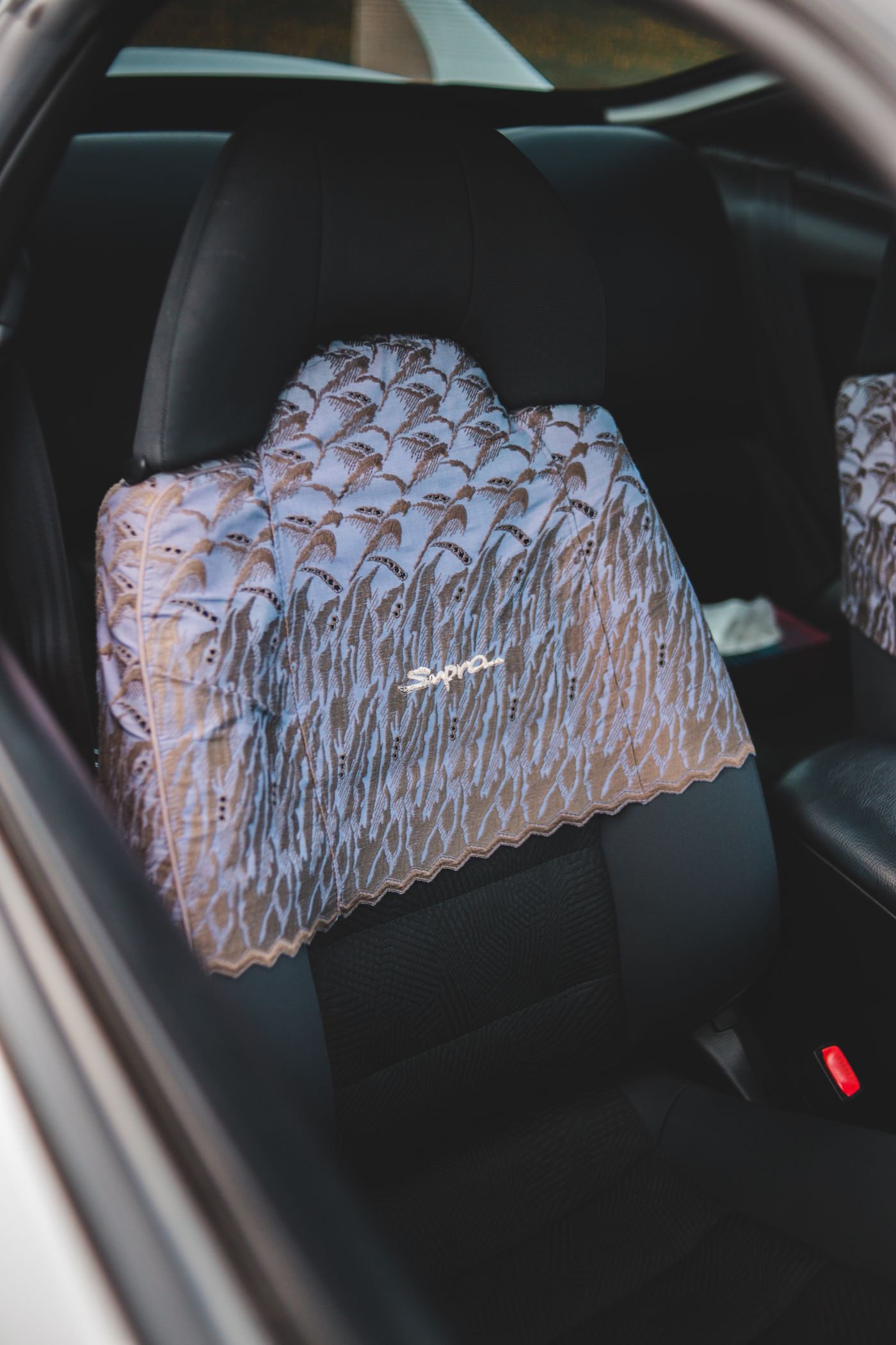 Car interior seat with fitted upholstery and protective seat covering