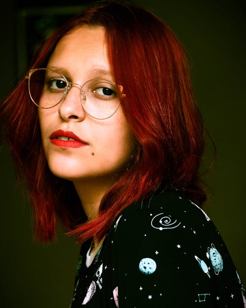 A Woman with Red Hair Wearing Eyeglasses