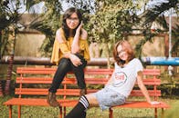 Women Sitting on Orange Bench