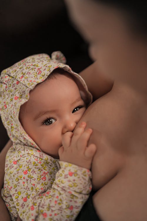 Close Up Photo of Baby Breastfeeding 