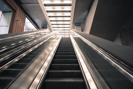 A modern indoor escalator under bright architectural lighting, showcasing sleek design.