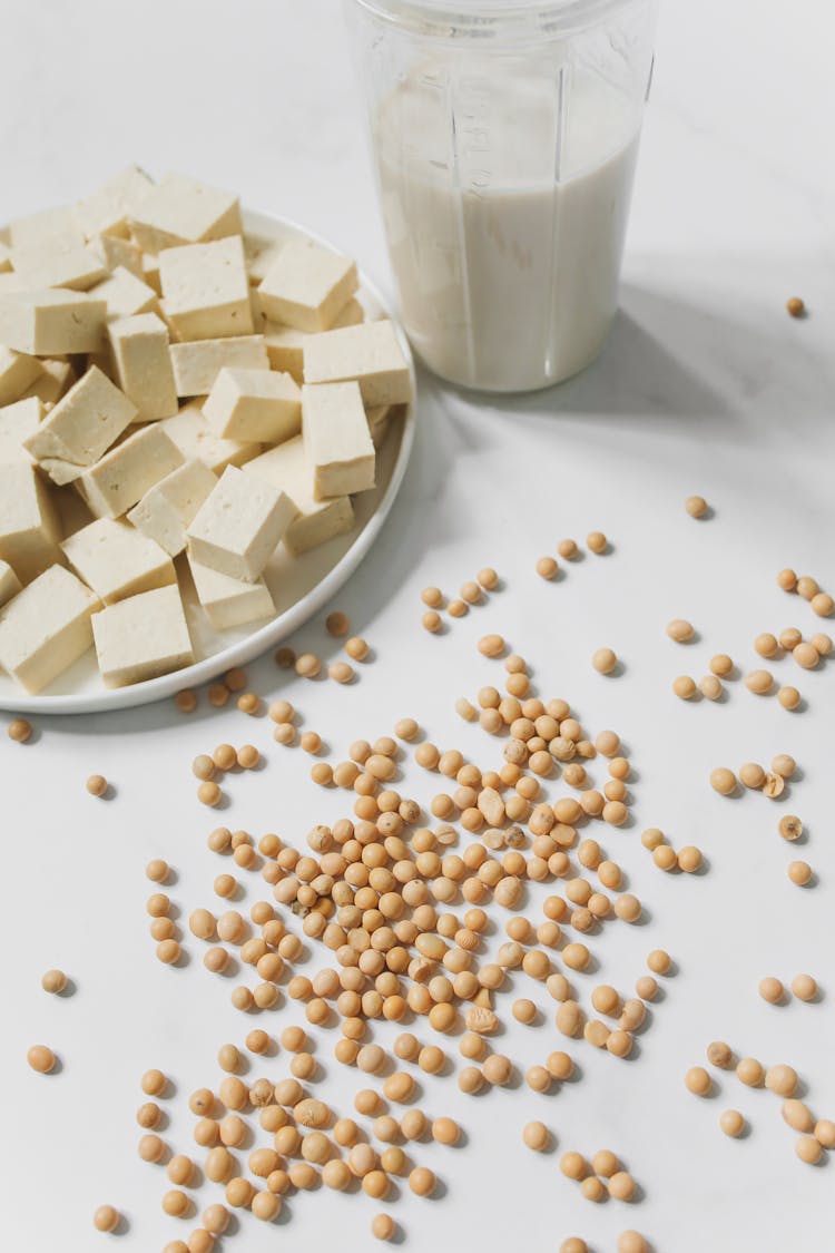 Photo Of Tofu, Soybeans And Soy Milk Against White Background