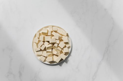 Free Top view of cubed tofu on a white plate, perfect for culinary projects Stock Photo