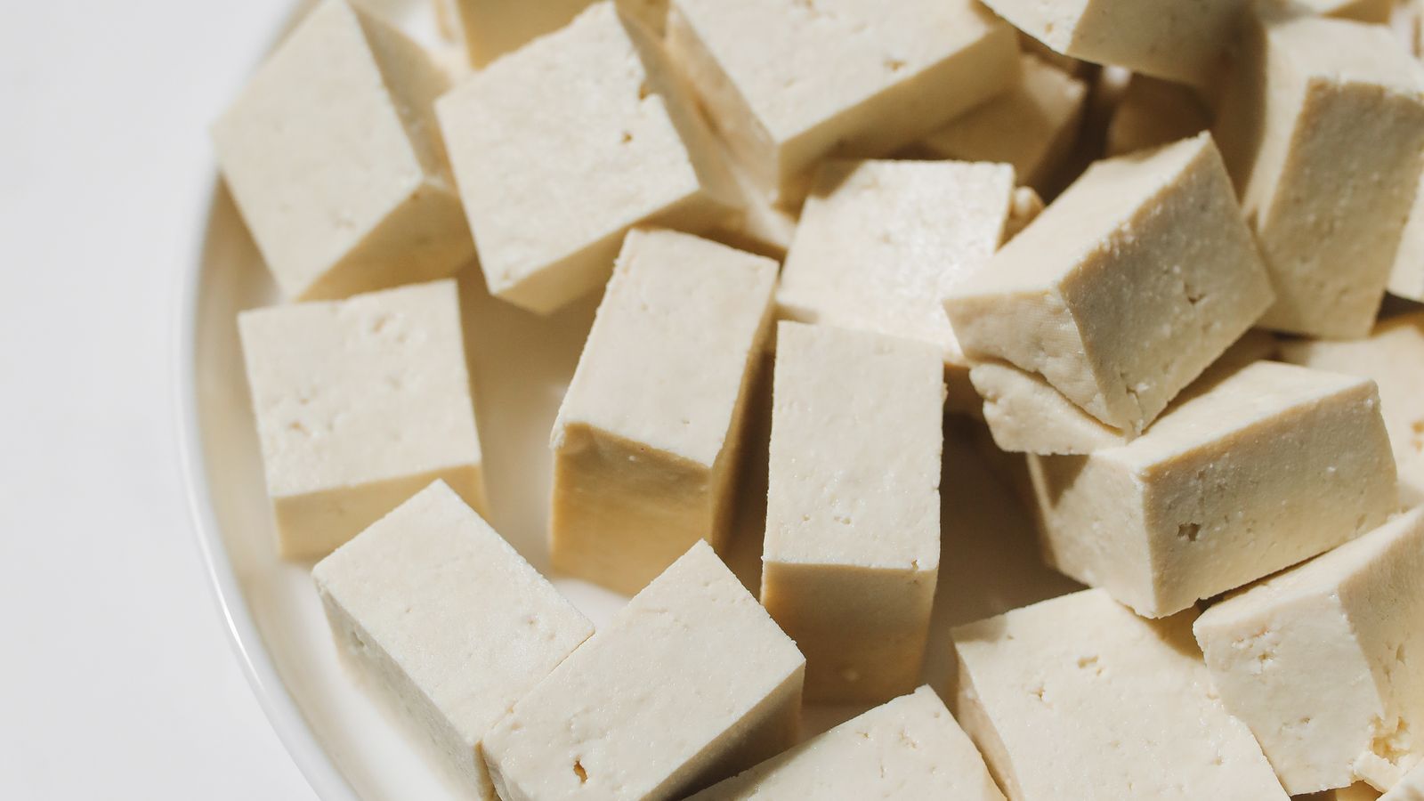 Fresh cubed tofu arranged on a white plate — photo by Polina Tankilevitch on Pexels Fresh cubed tofu arranged on a white plate