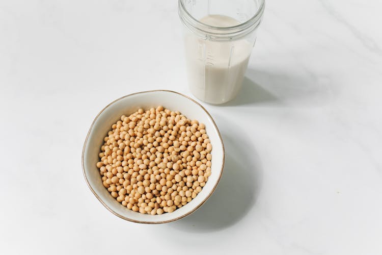 Photo Of Soybeans Near Drinking Glass With Soy Milk