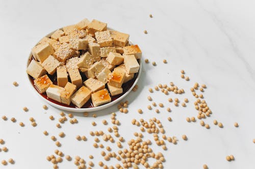 Free Sliced Tofu with Sesame Seeds on White Plate Stock Photo