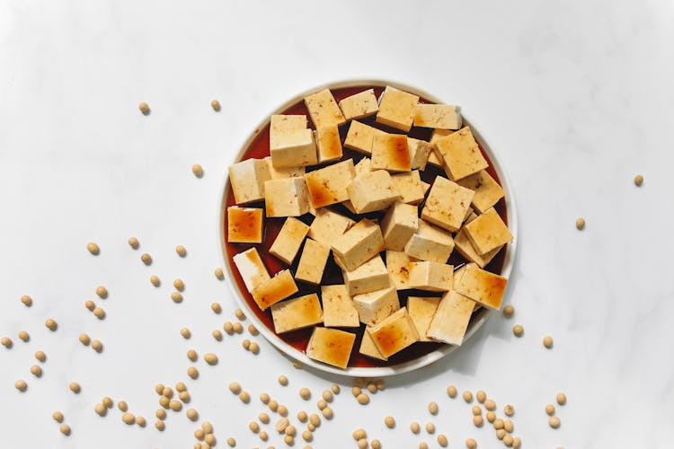 Sliced Tofu With Brown Liquid On White Ceramic Plate