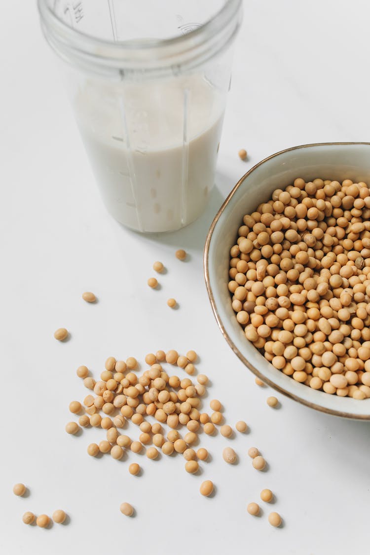 Photo Of Soybeans Near Drinking Glass With Soy Milk