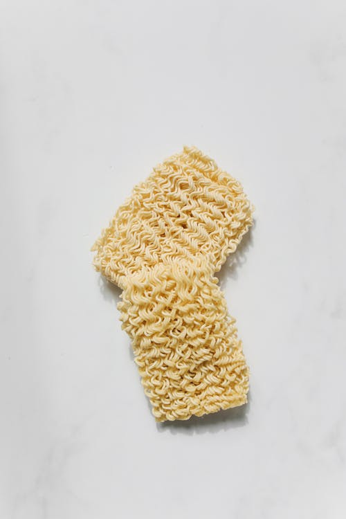 Photo of Yellow Uncooked Noodles on White Background