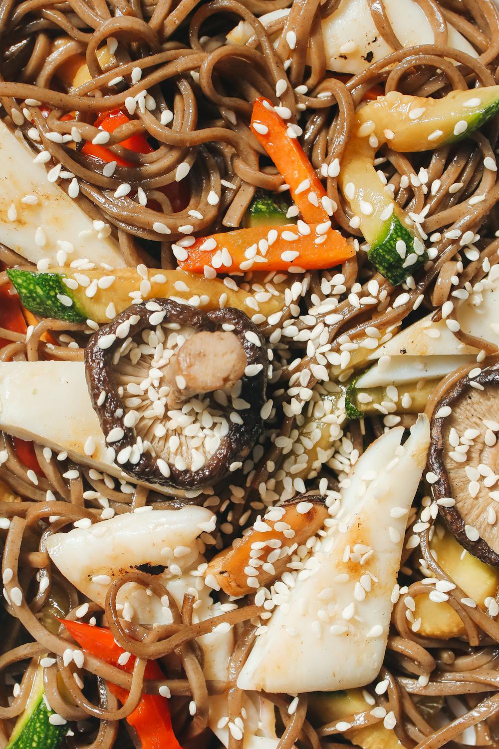 buckwheat noodles in an asian-styled stir-fry with sesame seeds on top