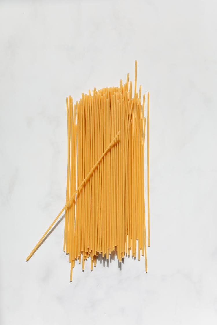 Uncooked Spaghetti Noodles On White Surface