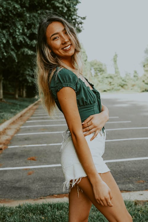 Positive ethnic woman on empty parking lot