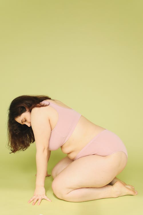 Curvy Brunette Woman Posing in Pink Underwear
