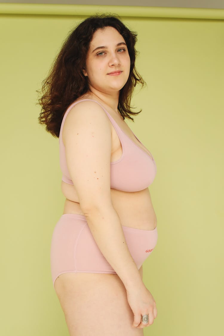 A Beautiful Chubby Woman Wearing Pink Underwear While Looking At The Camera