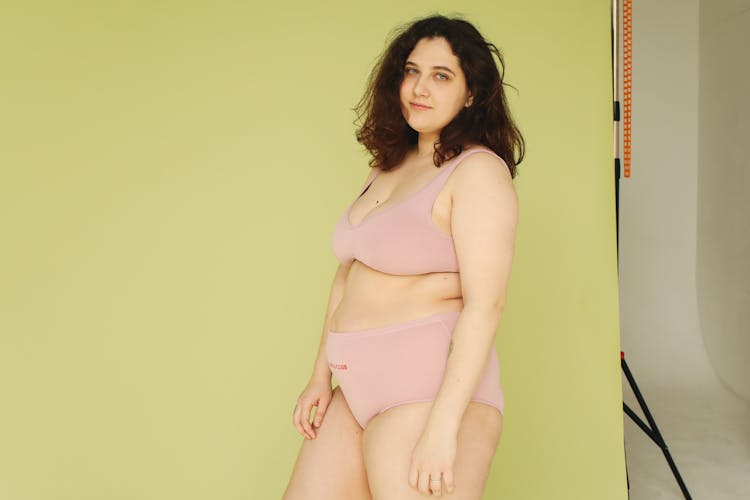 A Chubby Woman Wearing Pink Underwear While Posing At The Camera