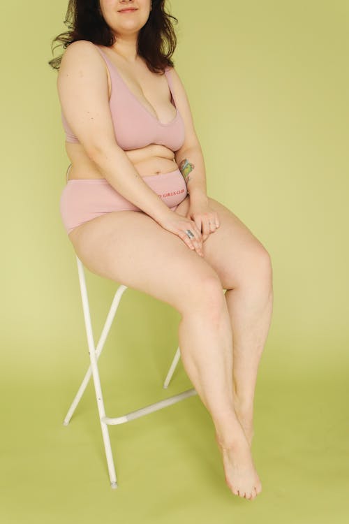 A Woman Sitting on White Chair