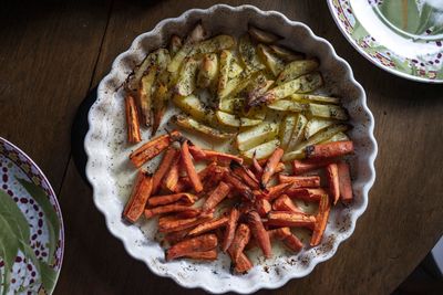 Roasted potatoes and carrots in a ceramic dish