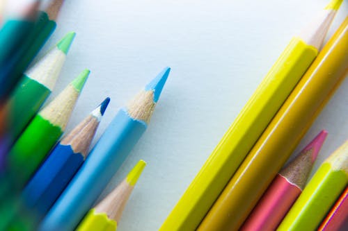 Close-up Shot of Colorful Pencils on a White Surface