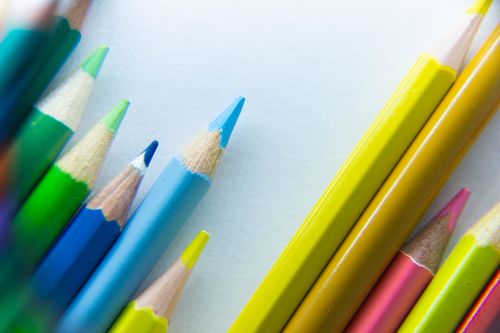 Free Close-up of colorful sharpened pencils arranged on a white surface, highlighting bright hues. Stock Photo