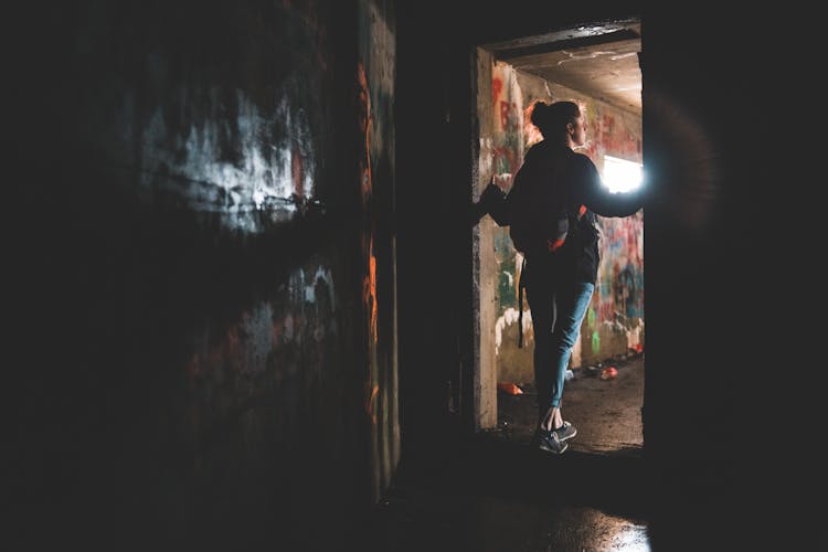 Unrecognizable Woman Standing In Doorway