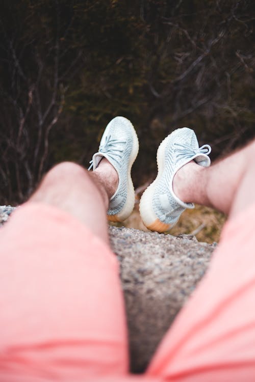 Unrecognizable man sitting on stone