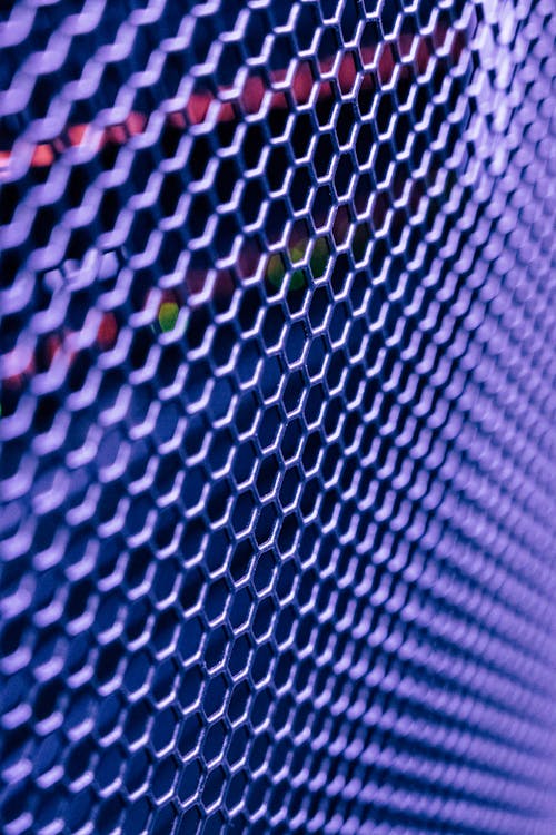 Free Closeup of lattice surface with glowing area arranged in many rows in back lit with led with violet neon in modern studio Stock Photo