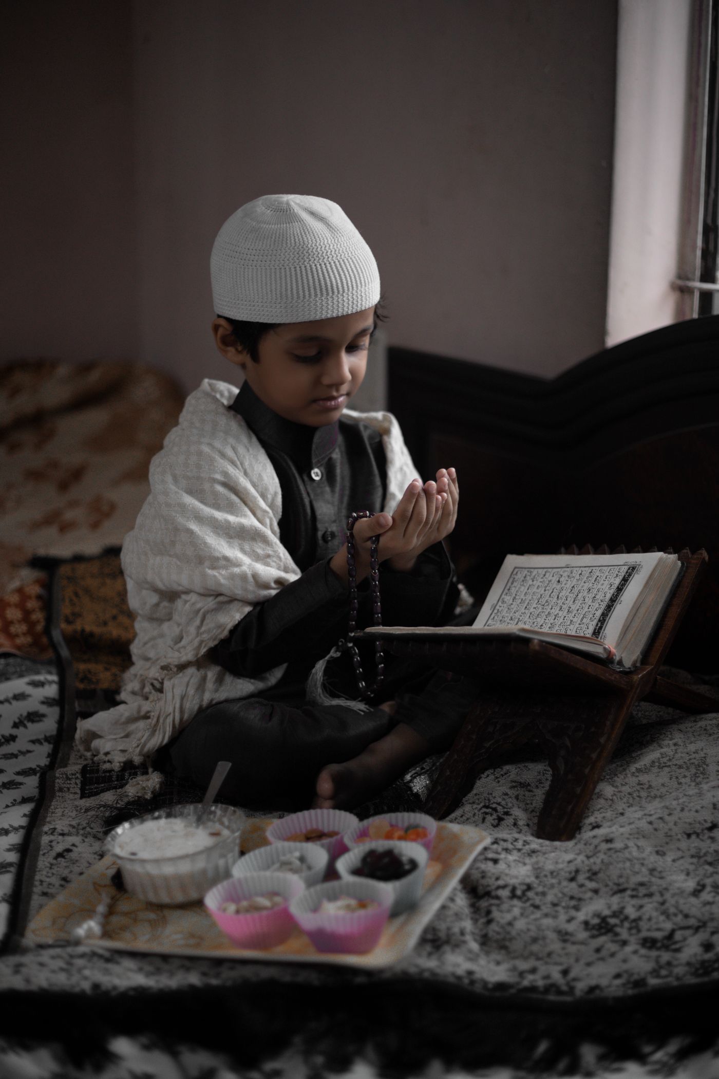 Muslim child studying Quran at home