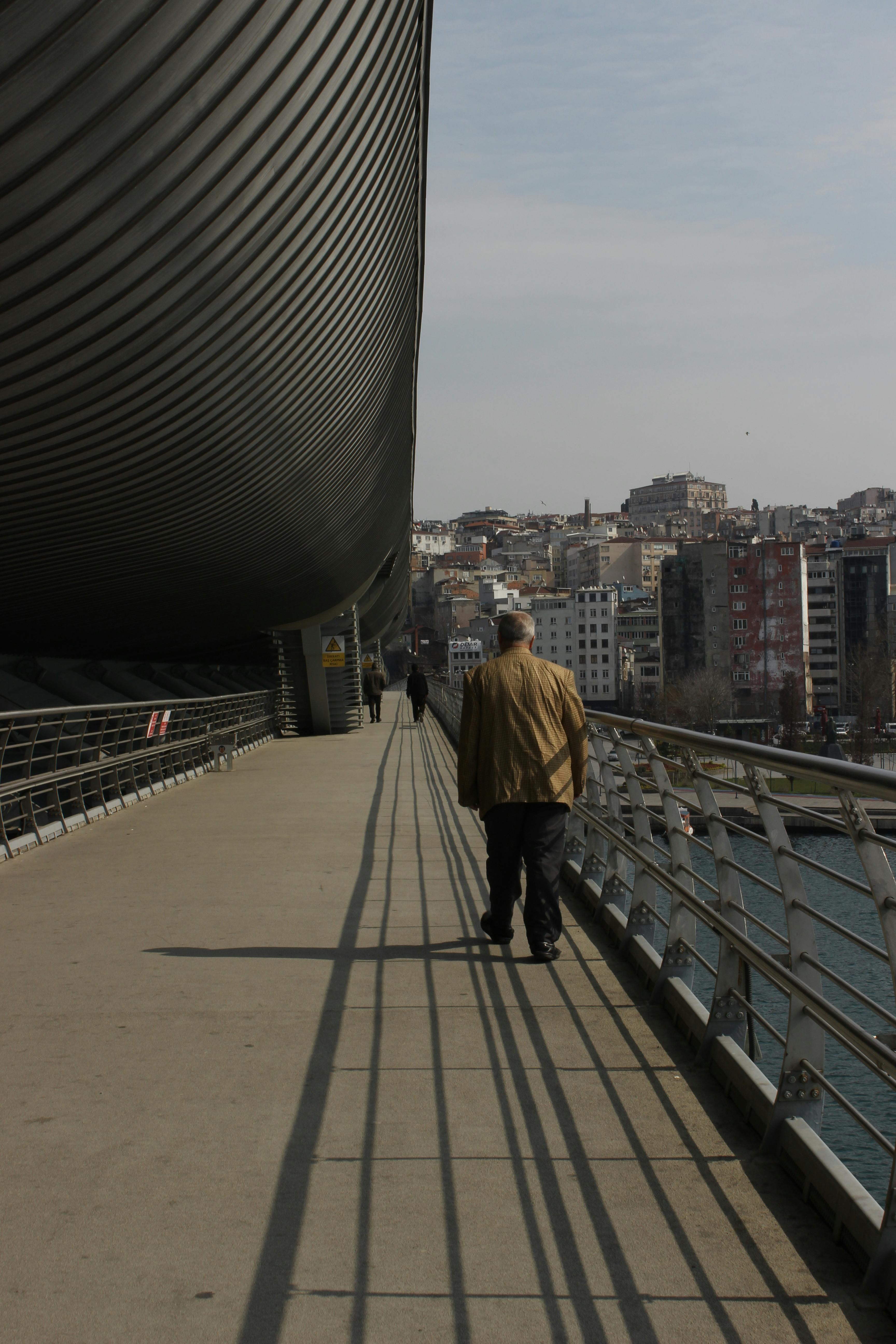 tramp walking on bridge across river