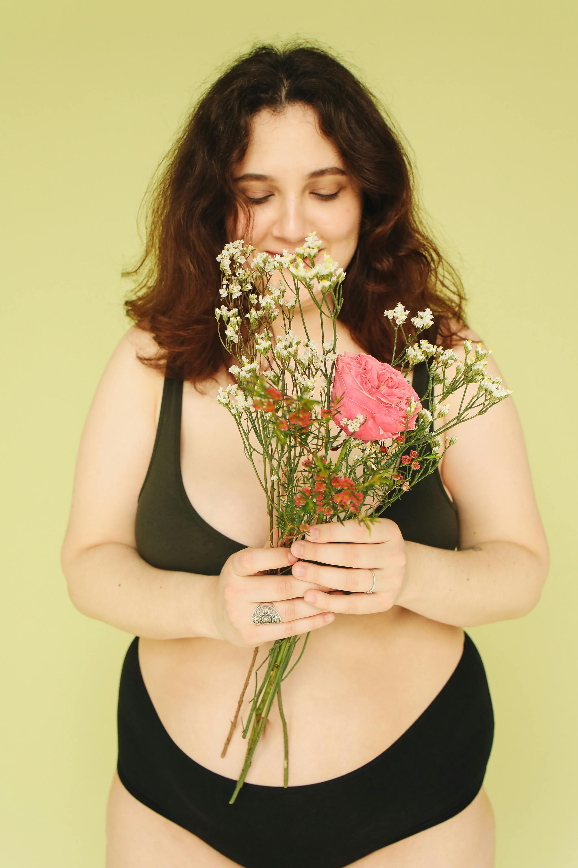 cropped shot of young woman in panties made of flowers isolated on grey  Stock Photo by LightFieldStudios