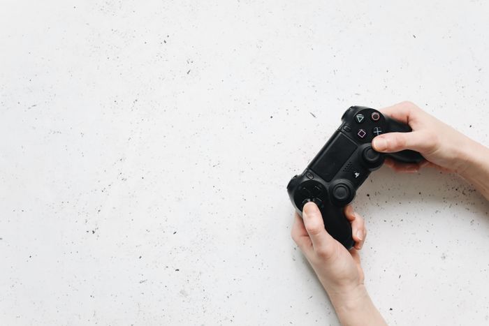 Hands holding a black game controller