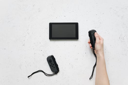 A person holds a Joy-Con controller with a Nintendo Switch on a white textured surface.