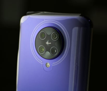 Detailed close-up of a smartphone camera lens on a purple device.