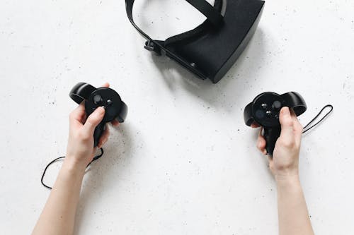 Person Holding Game Controllers