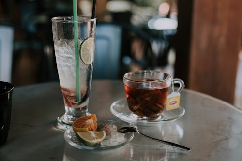 Free Cup of tea near refreshing drink in cafe Stock Photo
