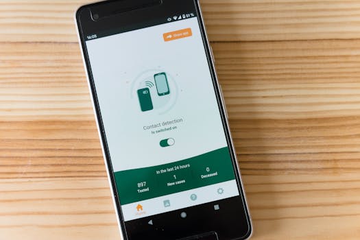 Smartphone displaying contact detection app interface on wooden table.
