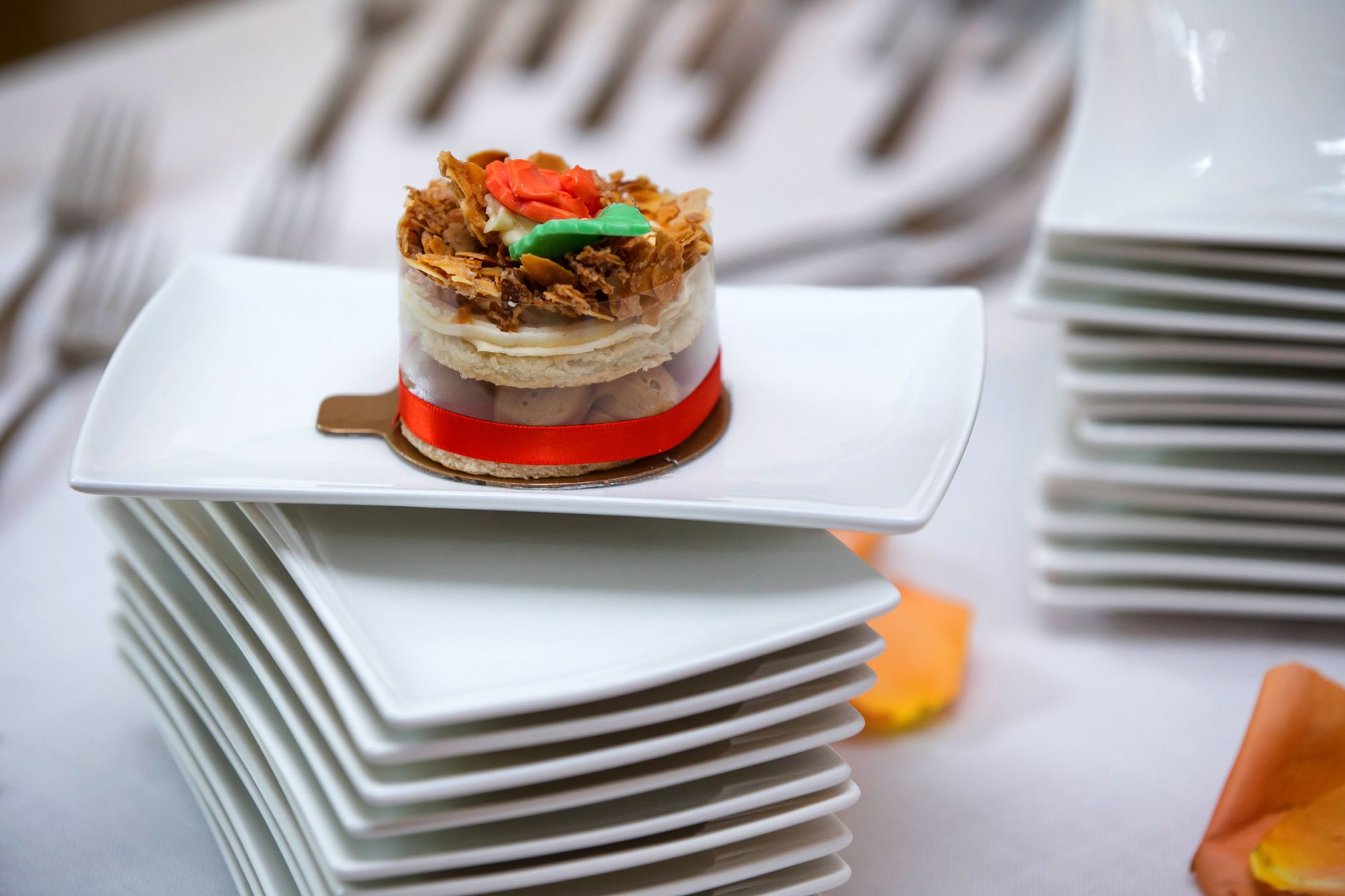 A gourmet dessert elegantly presented on stacked white plates, perfect for culinary displays.