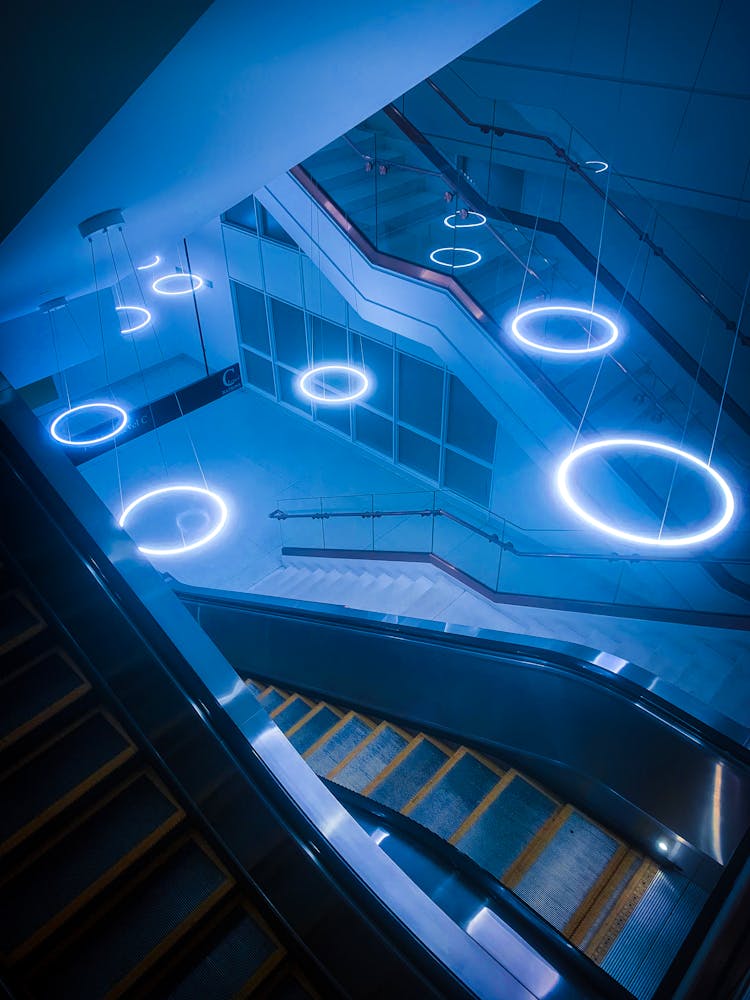 Escalator In Modern Building With Shiny Lamps