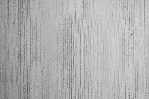 Free Close-up view of a textured white concrete wall showcasing vertical lines and surface intricacies. Stock Photo