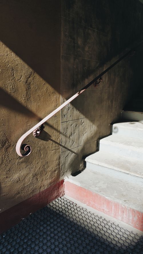 Free Beautiful vintage staircase in Sankt-Peterburg, Russia, with artistic handrail and dramatic shadows. Stock Photo