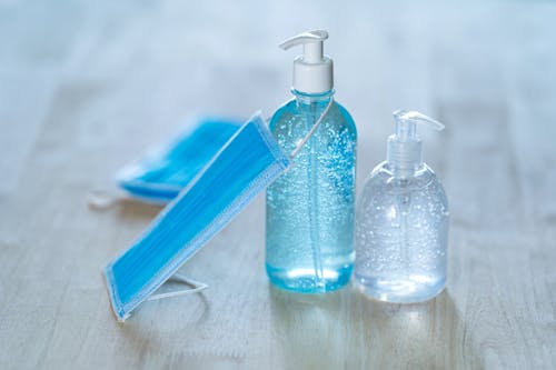 Free Dispensers with liquid soap and antibacterial gel with medical mask Stock Photo