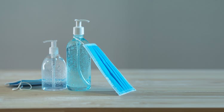 Liquid Soap And Antibacterial Gel In Dispensers With Sterile Mask