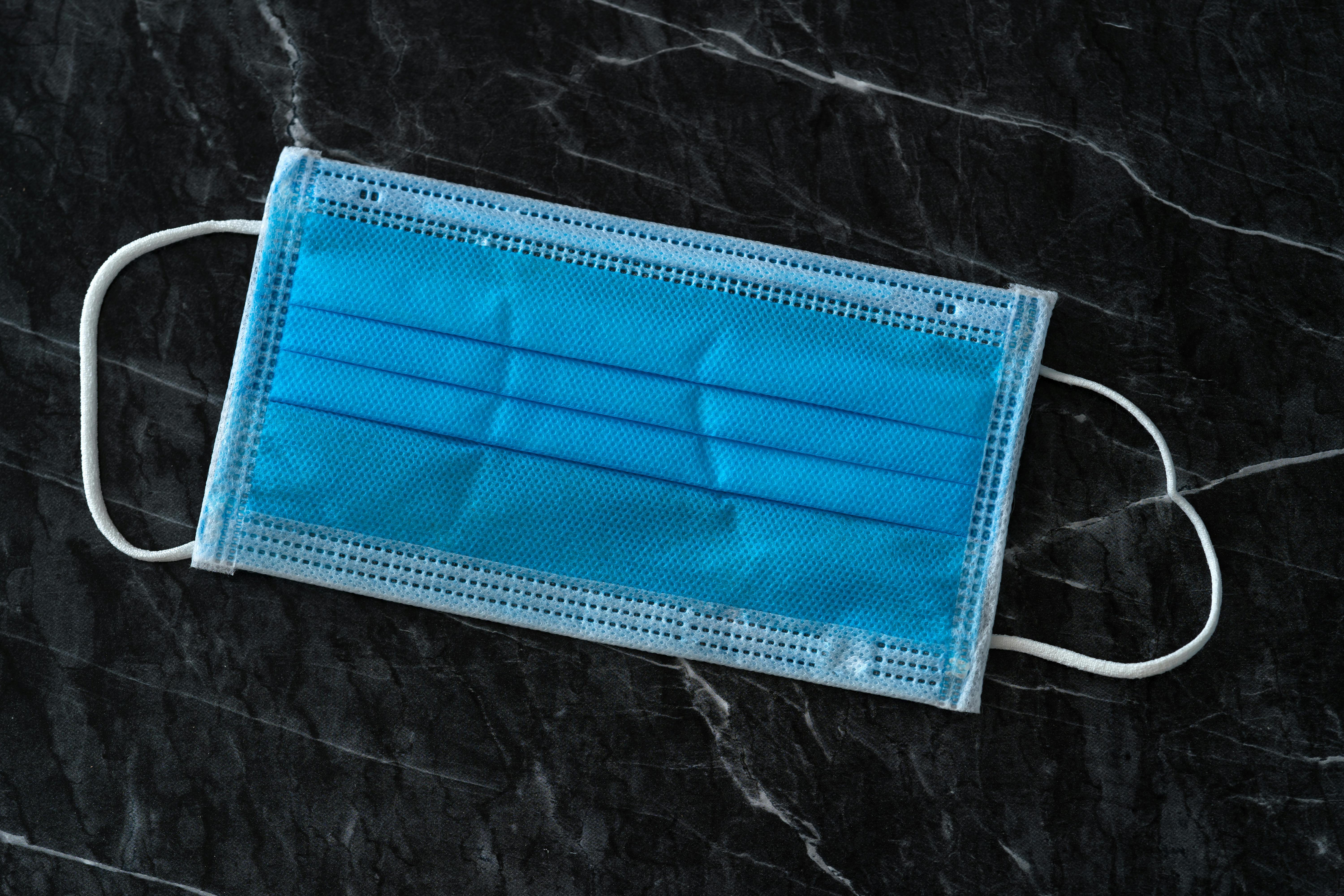 disposable medical mask on table during quarantine period