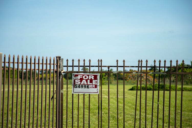 Fenced Plot Of Land With For Sale Sign 