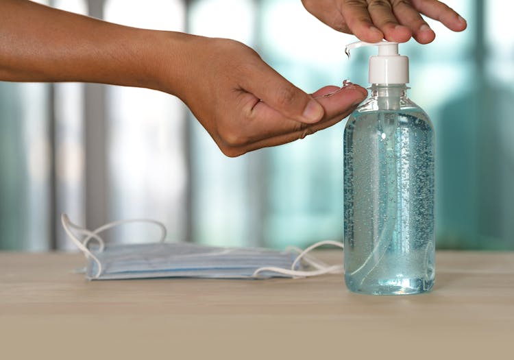 Faceless Person Using Antibacterial Gel From Dispenser During Quarantine Period