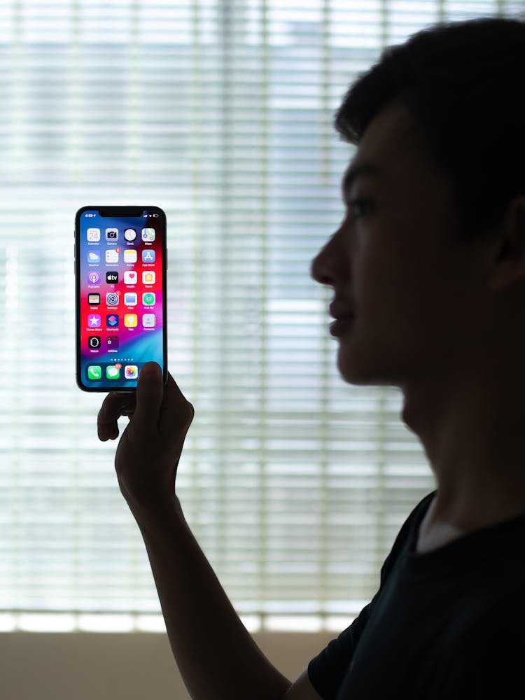 Woman In Black Shirt Holding Silver Iphone 6