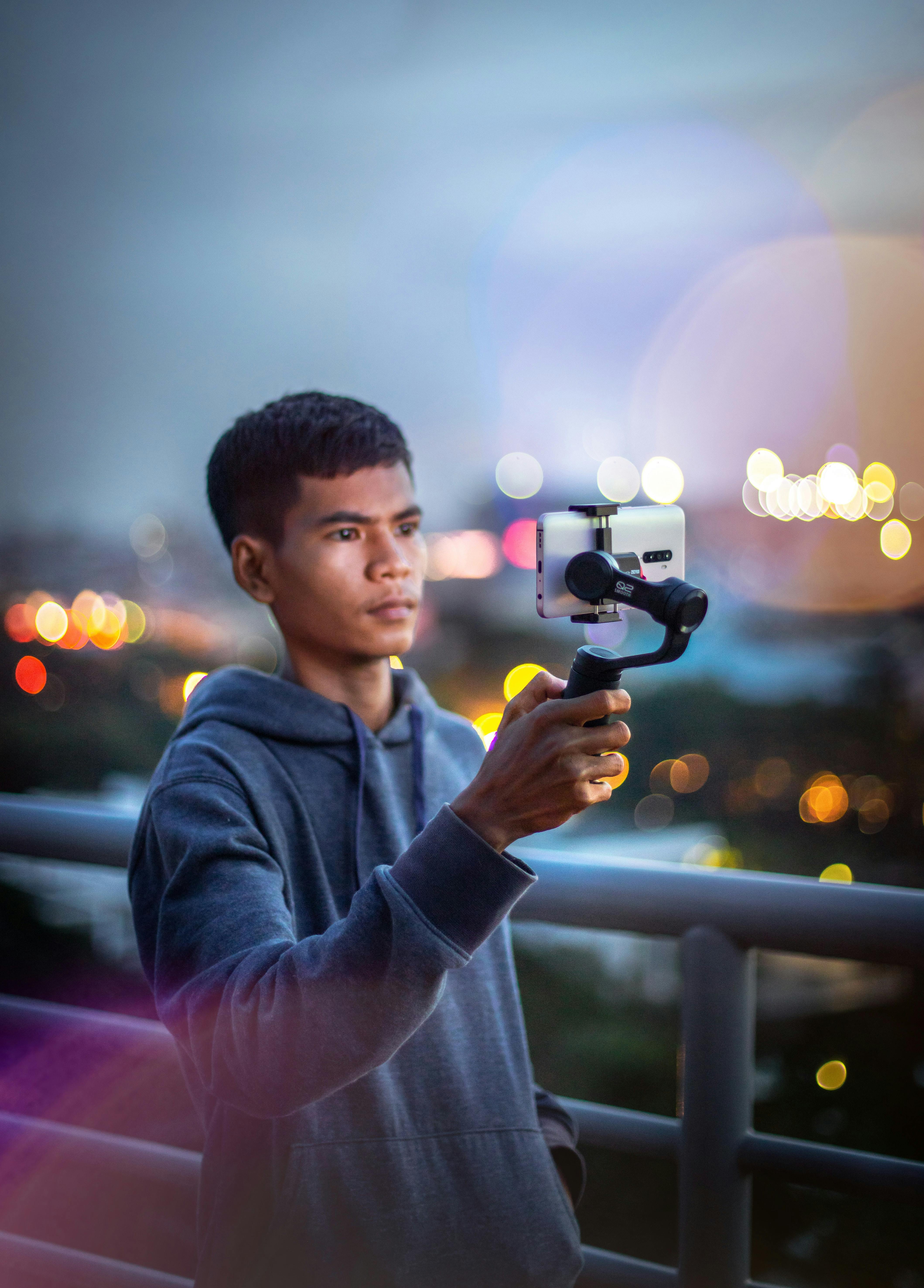 asian blogger recording video on smartphone on street